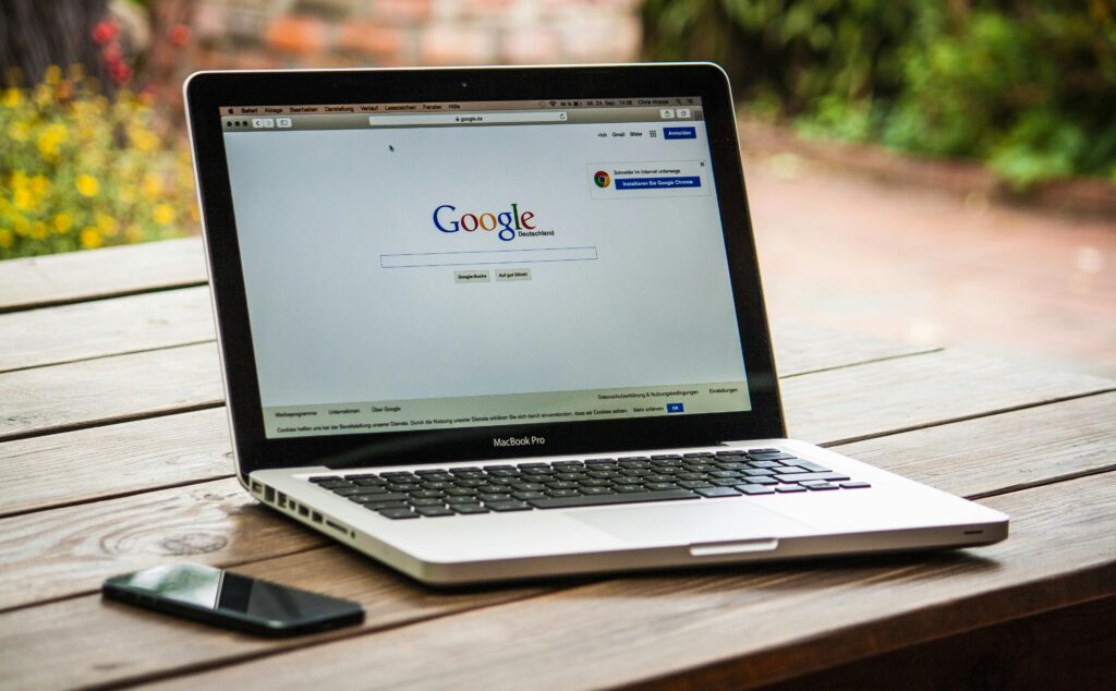 Laptop showing the Google home page. Website design helps Montgomery County businesses show up when people use the search engine. 
